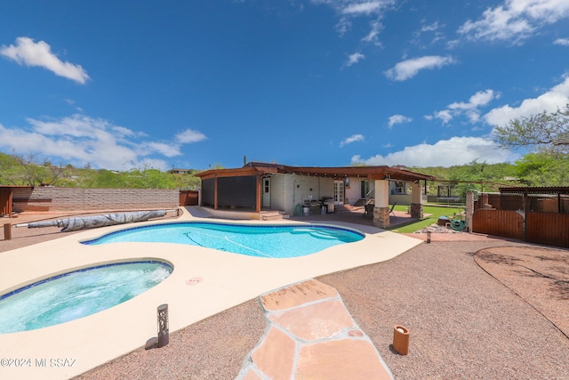 view of swimming pool with an outdoor hot tub and a patio area