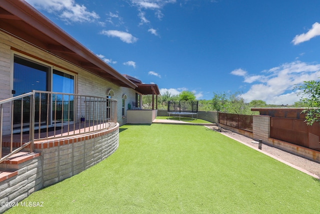 view of yard with a trampoline