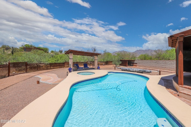 view of swimming pool featuring a mountain view and a patio area