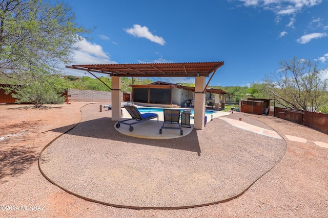 view of patio / terrace with a pergola and a fenced in pool