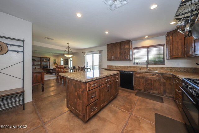 kitchen with tile flooring, a center island, sink, black appliances, and pendant lighting