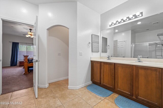 tiled dining space with ceiling fan with notable chandelier