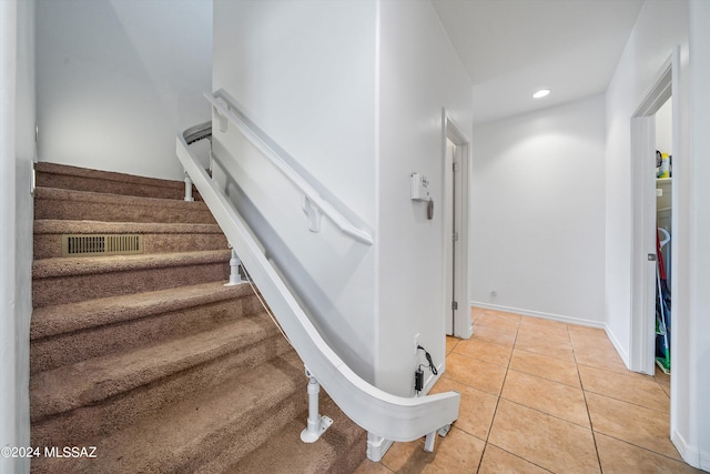 staircase featuring tile patterned floors