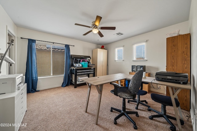 carpeted office featuring ceiling fan