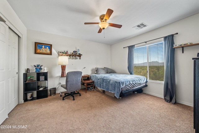 bedroom featuring carpet, ceiling fan, and a closet