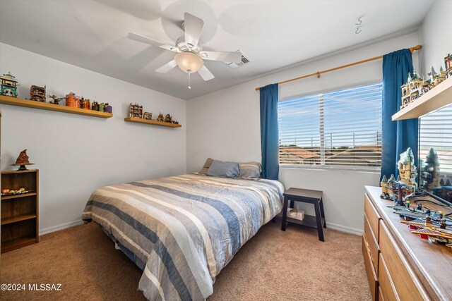 bedroom with light carpet and ceiling fan