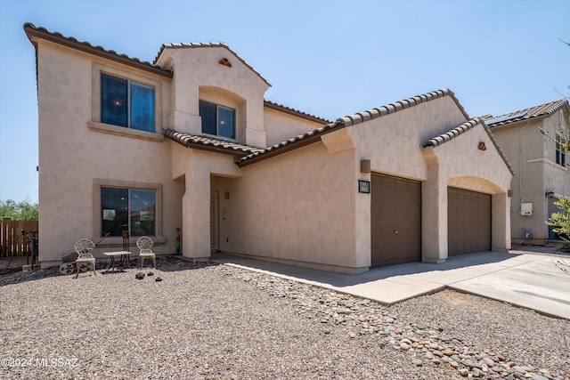 mediterranean / spanish-style house featuring a garage