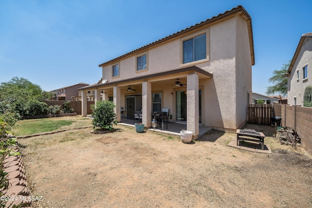 back of house with ceiling fan and a patio area