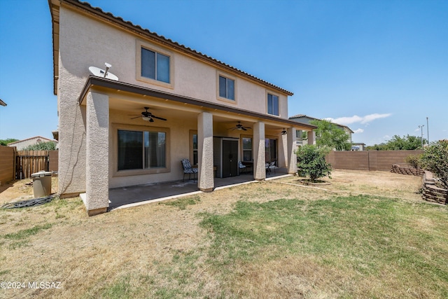 back of property with a patio, ceiling fan, and a lawn