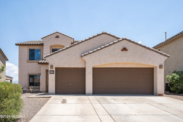 mediterranean / spanish-style home with a garage