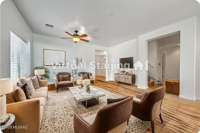 tiled living room with ceiling fan