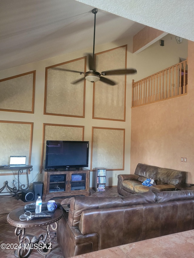 living area featuring lofted ceiling and a ceiling fan