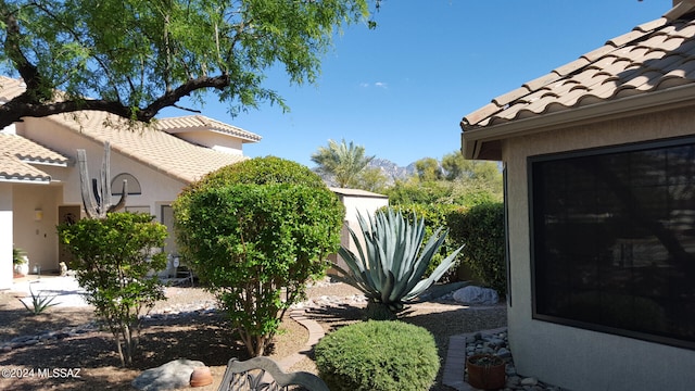 view of home's exterior featuring a tiled roof and stucco siding