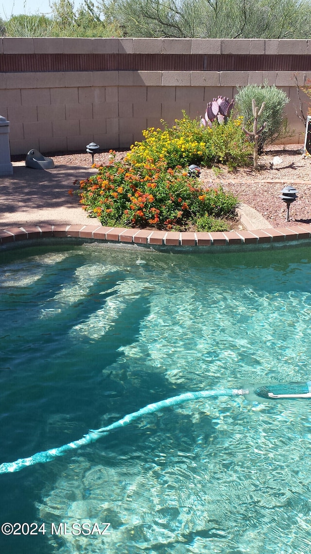 view of pool featuring fence