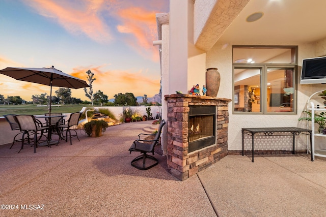 view of patio featuring an outdoor stone fireplace