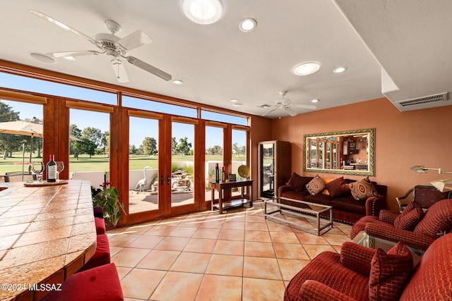 tiled living room featuring french doors and ceiling fan