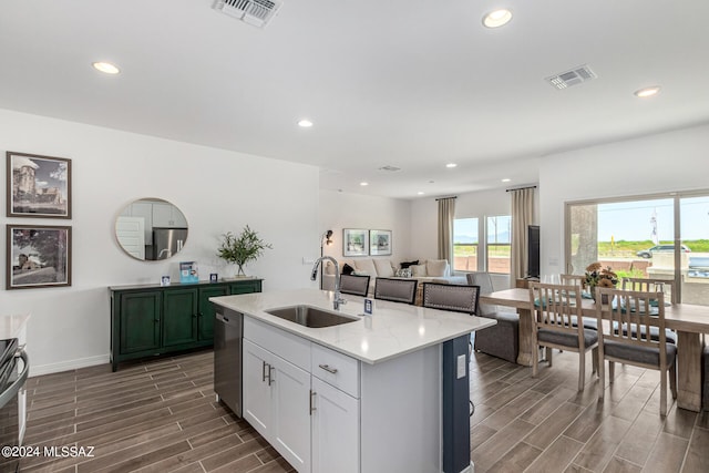 kitchen with white cabinets, appliances with stainless steel finishes, sink, and dark hardwood / wood-style floors