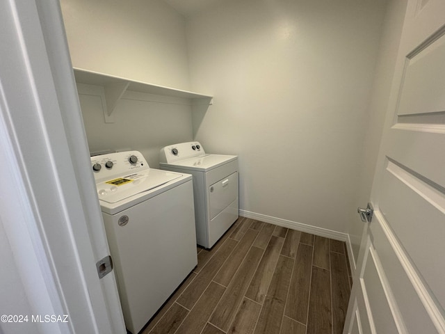 washroom featuring dark wood-type flooring and separate washer and dryer