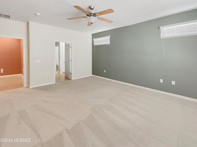 carpeted spare room with ceiling fan