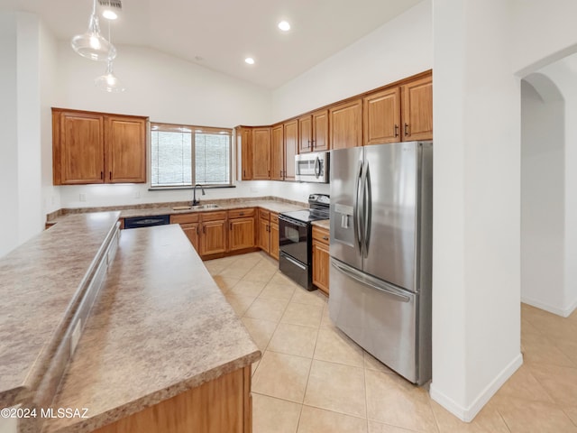 kitchen with decorative light fixtures, sink, appliances with stainless steel finishes, and light tile floors