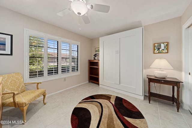 sitting room featuring ceiling fan and light tile patterned floors