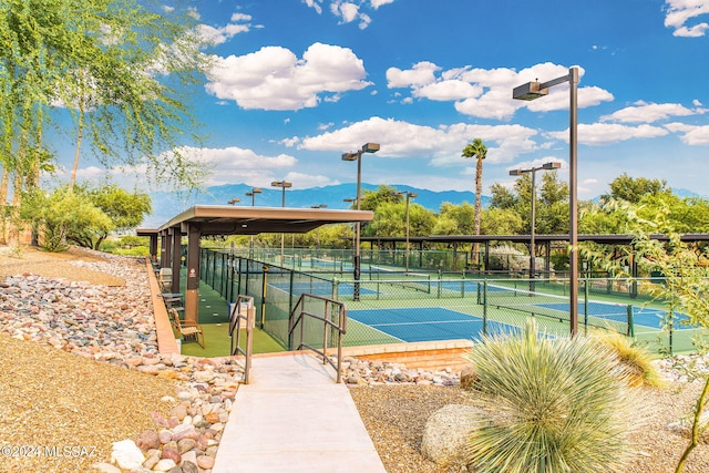 view of tennis court featuring a mountain view