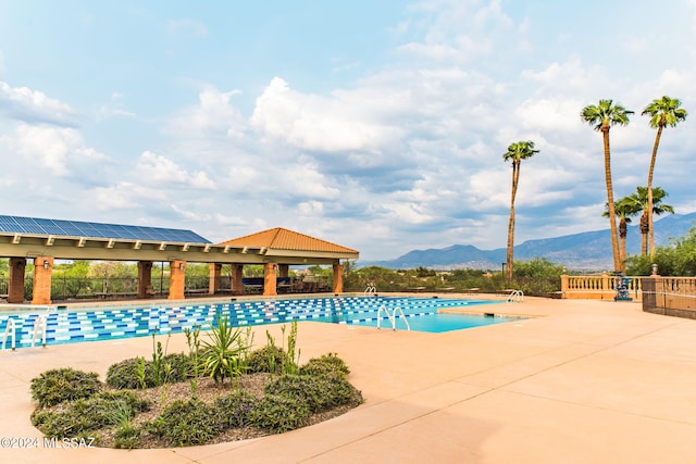 view of swimming pool with a mountain view