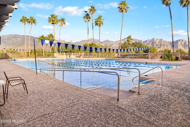 view of pool with a mountain view and a patio area