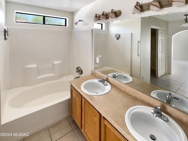 bathroom featuring vanity, tile patterned flooring, and  shower combination