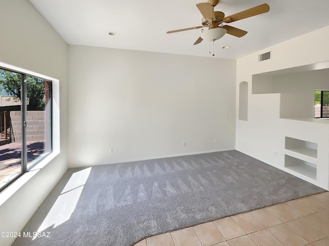 unfurnished living room with ceiling fan and light colored carpet