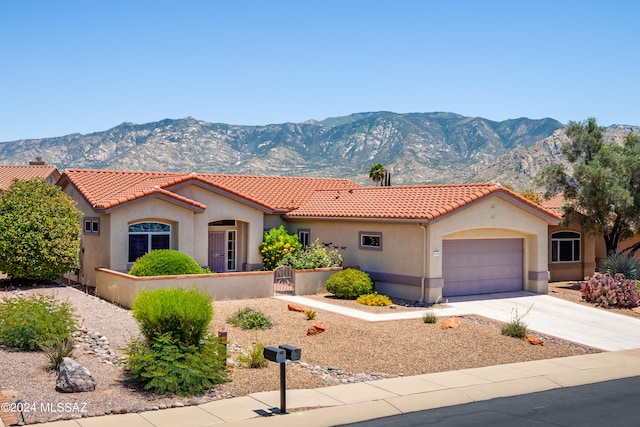 view of front facade with a mountain view and a garage