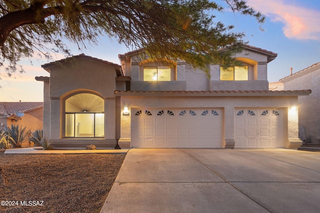 mediterranean / spanish-style home with a garage