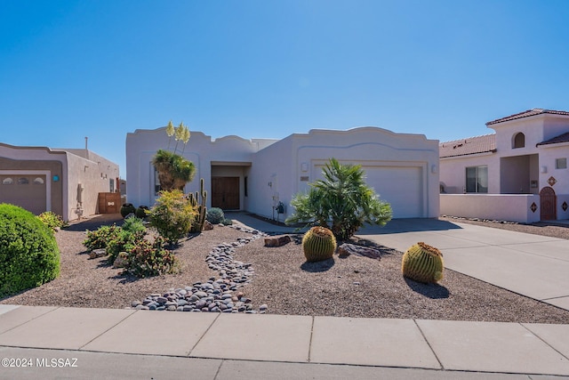 southwest-style home with a garage