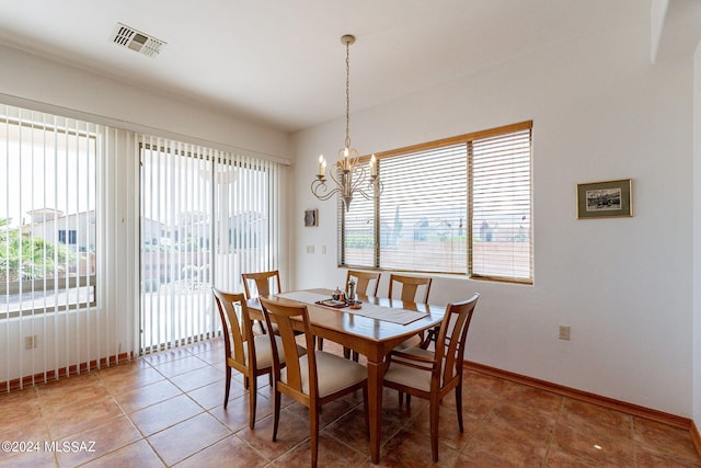 dining space featuring a notable chandelier and tile flooring