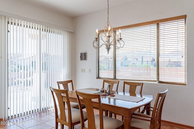 tiled dining space featuring a chandelier