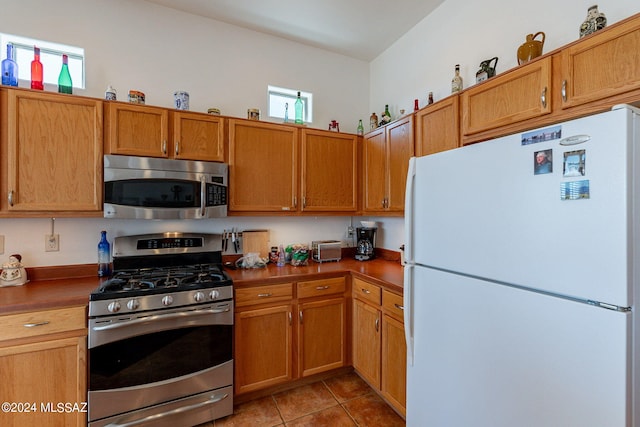 kitchen featuring appliances with stainless steel finishes and light tile floors