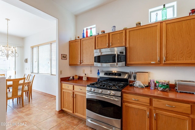 kitchen featuring stainless steel appliances, plenty of natural light, and pendant lighting