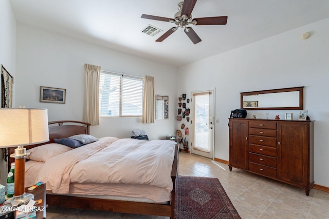 tiled bedroom with ceiling fan and access to exterior