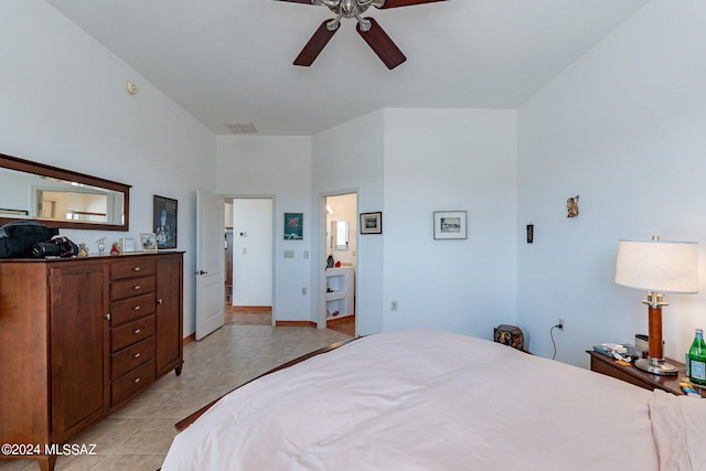 bedroom featuring ensuite bath, ceiling fan, and light tile floors