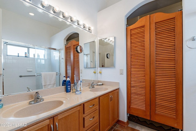 bathroom with tile floors, dual sinks, and vanity with extensive cabinet space