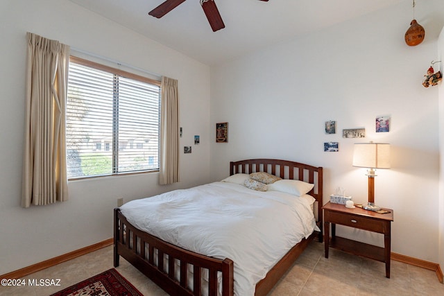 tiled bedroom with vaulted ceiling and ceiling fan