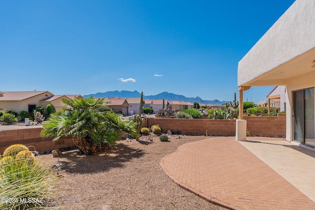 view of yard featuring a patio and a mountain view