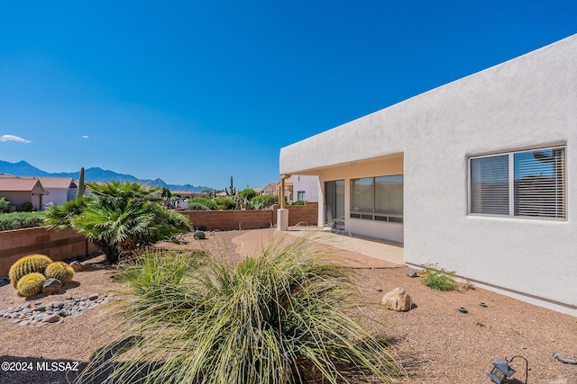 view of yard featuring a patio and a mountain view