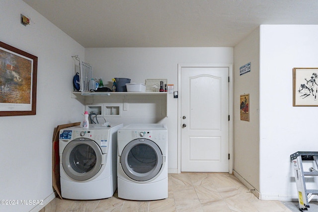 laundry area with washer and dryer, light tile floors, and washer hookup