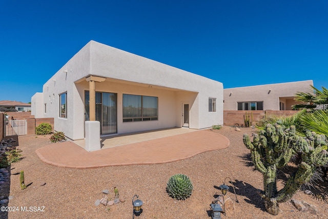 rear view of property featuring a patio