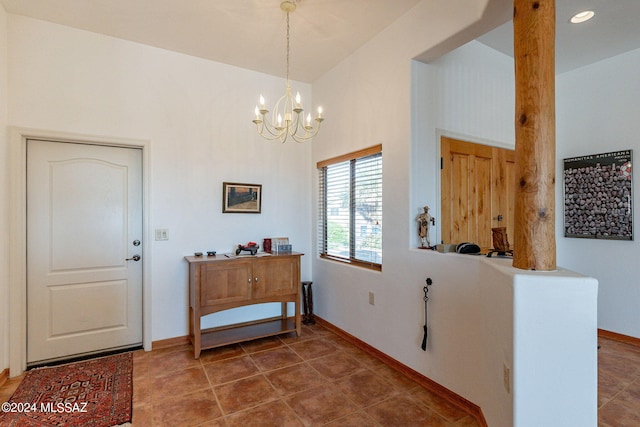 tiled entrance foyer featuring a notable chandelier