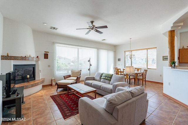 living room with plenty of natural light, tile flooring, and a fireplace