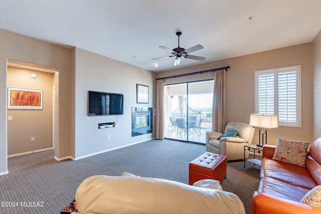 living room with ceiling fan and carpet