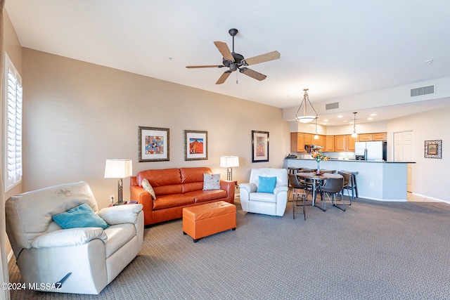 carpeted living room featuring a healthy amount of sunlight and ceiling fan