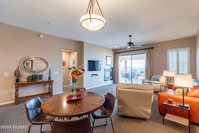 dining space with carpet floors and ceiling fan